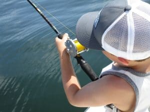 Boy learning to fish