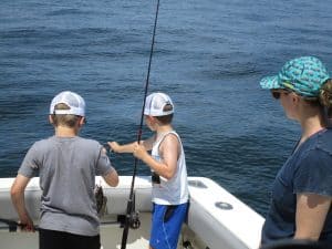 The boys fishing from the stern